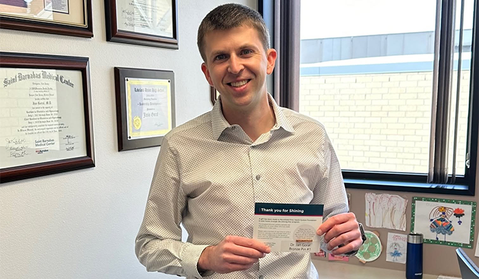 Man holding certificate in an office