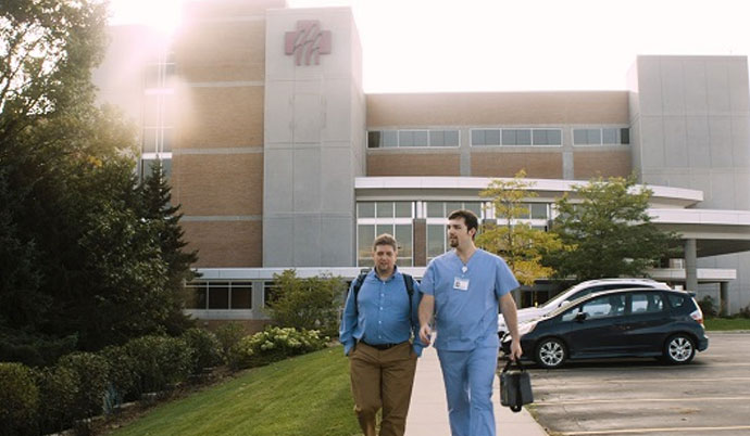 2 men leaving a hospital