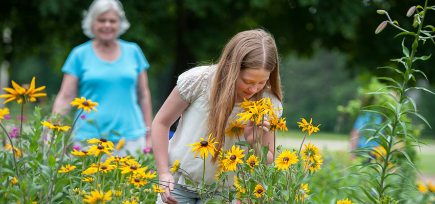 Girl smelling flowers