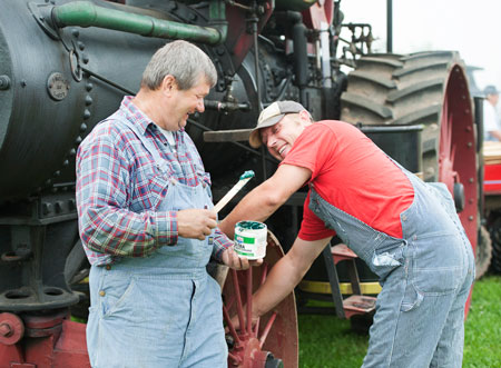 man with lower back pain working on steam engine 