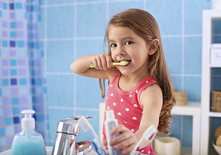 Young girl brushing her teeth