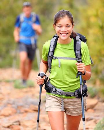 Woman hiking using walking poles