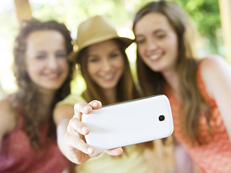 Girls taking selfie with smartphone