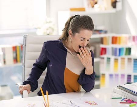 woman yawning while at work