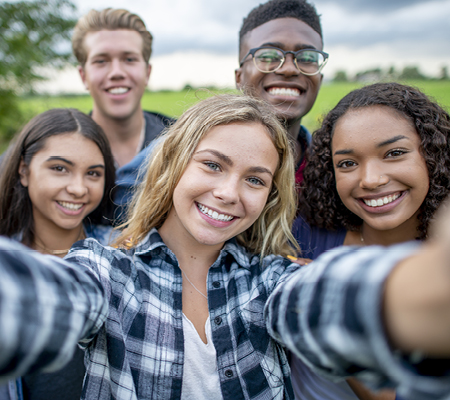 Teens take photos with friends 