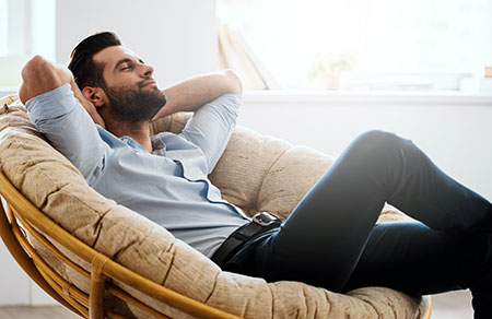Man relaxing in a chair - Avoiding burnout
