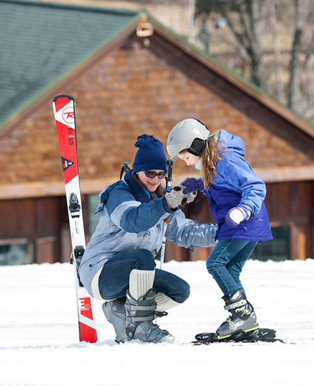 Young girl learning how to ski safe