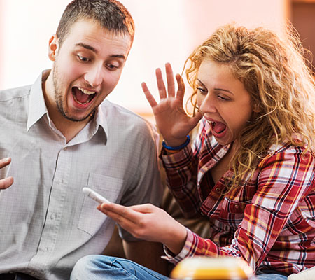 Man and woman excited about a pregnancy test