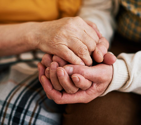 Hands held together to discuss tremors and stop hand shaking.