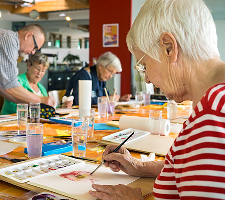 Elderly woman painting