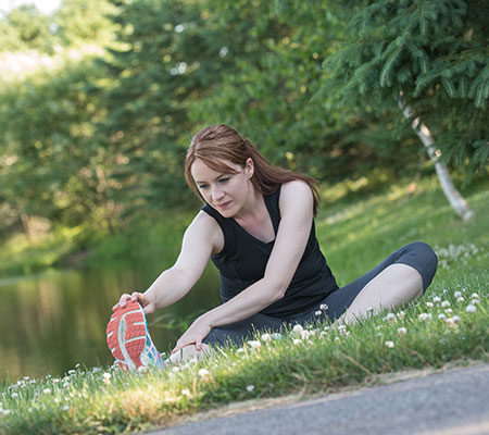 Woman stretching in grass
