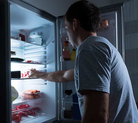 Man opening fridge for late night snack