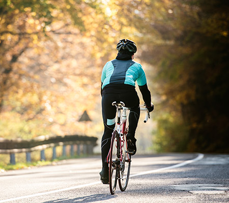 Women riding bicycle after recovering from a summer sports injury