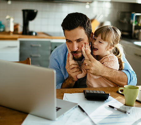 Dad and daughter looking at laptop trying to figure out how to choose a pediatrician