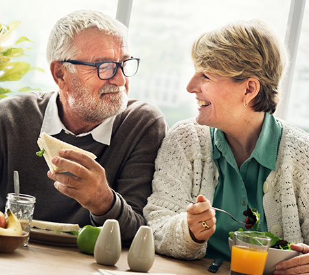 Senior man and woman eating breakfast together smiling - Cardiotoxicity