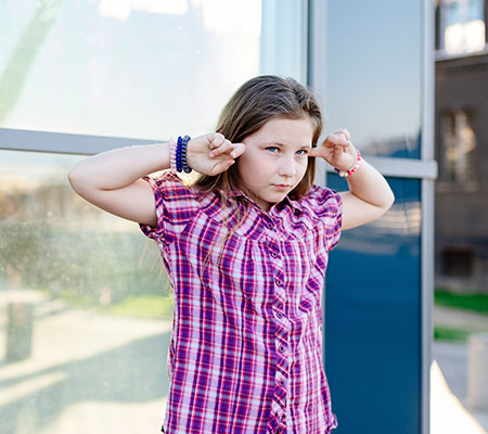 Girl plugging her ears - Frequent ear infections, ear infection treatment
