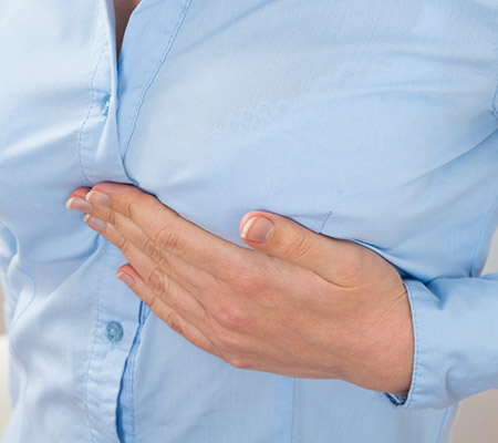 Woman feeling her breast - Breast pain