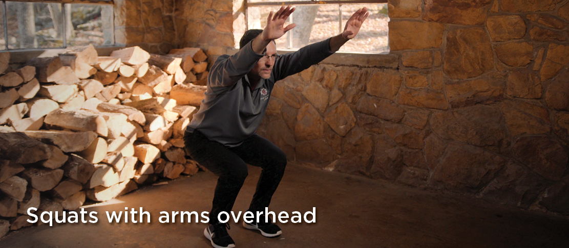 squats with arms overhead warmup before exercise