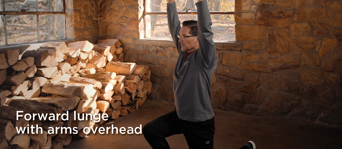 forward lunge with arms overhead cold weather warmup before exercise