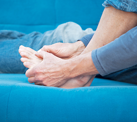 Person massaging and checking out toes on feet - Bunions