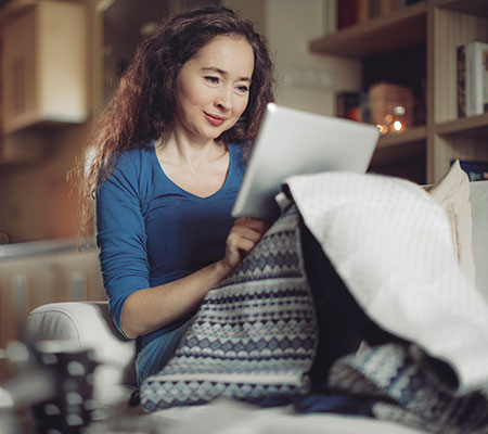 Mature woman reading an article on her tablet - Menopause and heart disease