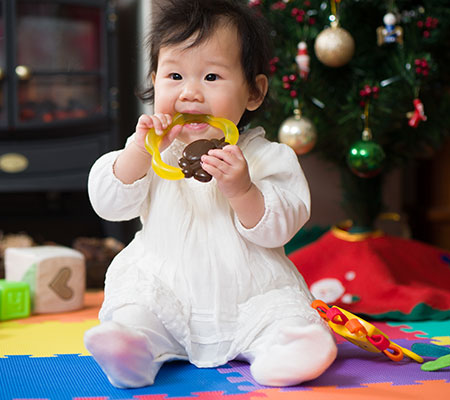 Baby chewing on a teething ring - How to soothe teething