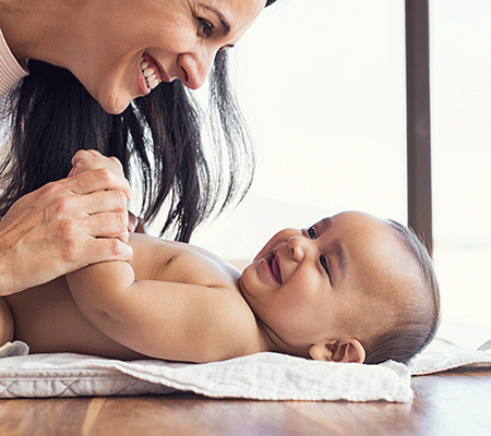 Mother and baby playing together on a bed - Placenta eating