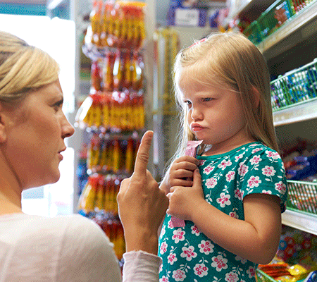 Mother managing toddler tantrums in a grocery store - Managing temper tantrums