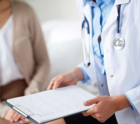 Doctor with a clipboard, meeting with a patient - Alcohol and substance use screening