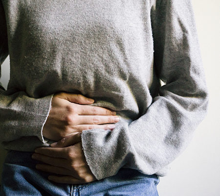 Woman holding her stomach - Endometriosis