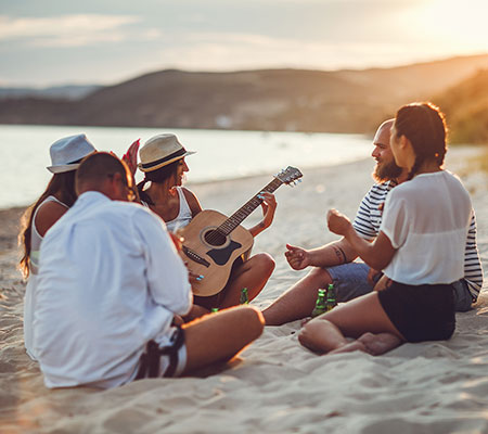Spring breakers on a beach having a good time - Spring break safety tips