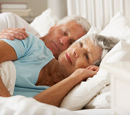 Senior woman having trouble falling asleep - Cancer and sleep loss