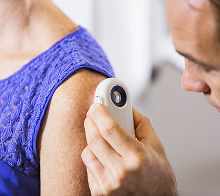 Doctor examining a patient's skin - Weird spot on your skin