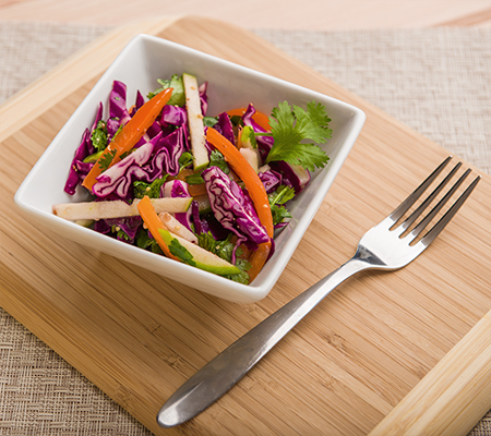 Bowl of red cabbage coleslaw with apples - Apple Cider Vinegar and Red Cabbage Coleslaw with Apples