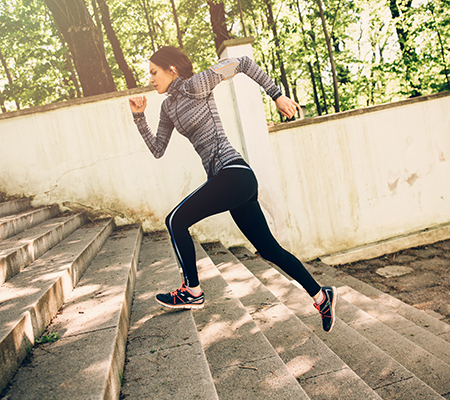 Woman running up a flight of stairs outside - Rhabdomyolysis
