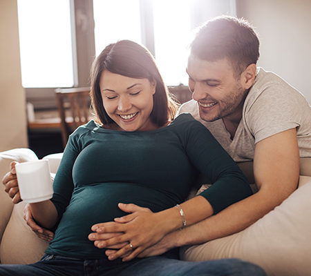 two young parents laughing / nitrous oxide use in child birth