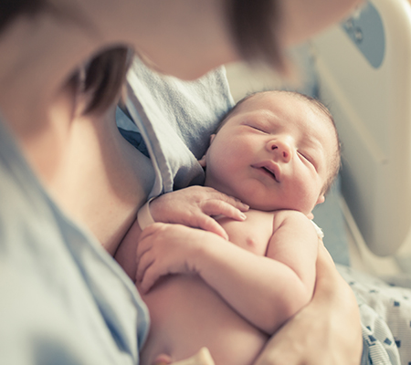 Newborn baby in mother's arms - Infant head shape
