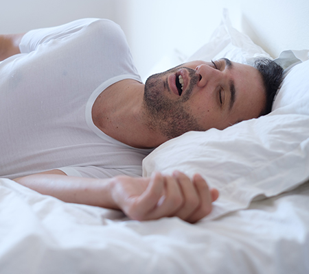 Man snoring on his bed - Night shift sleep tips