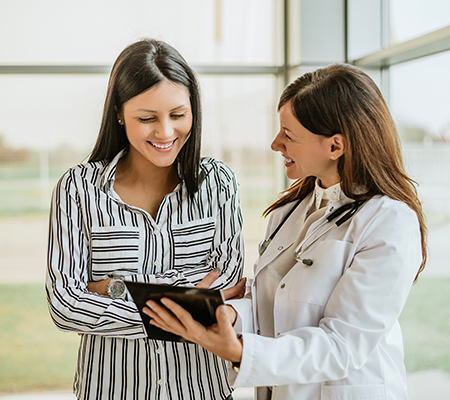 Female patient looking at records with her doctor - Emergency room follow-up care