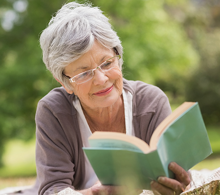 Senior woman reading a book - Medicare Annual Wellness Visit, adult checkups