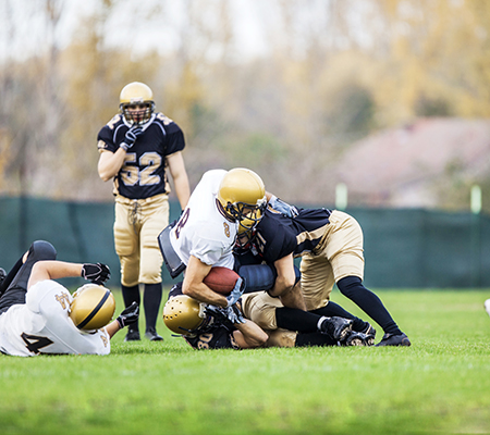 Football players tackling - Broken ribs