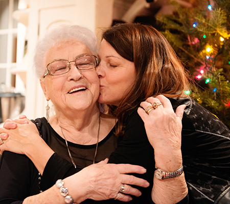 Grandmother and daughter hugging at Christmas - Holiday heart attacks