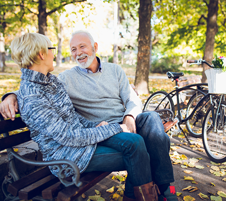 Two seniors enjoying a bike ride in the park - Low-dose naltrexone