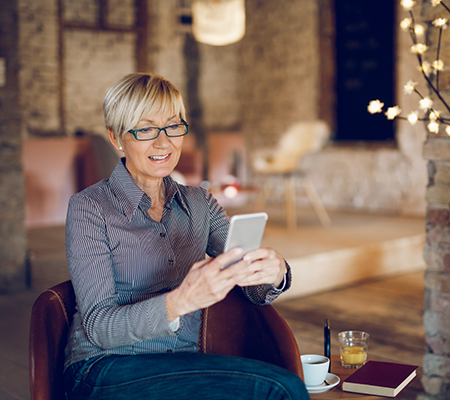 Middle-aged woman using her mobile phone - Online medication apps