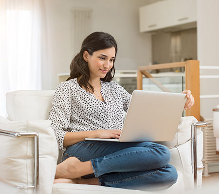 woman using her laptop computer / online apps for medication