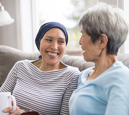 Cancer patient laughing with relative - Linear accelerator