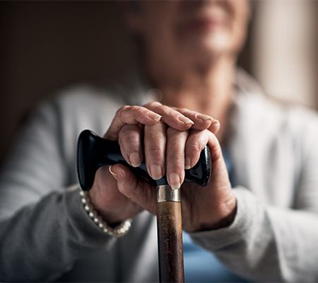 Woman holding a cane out - What is Parkinson's disease?