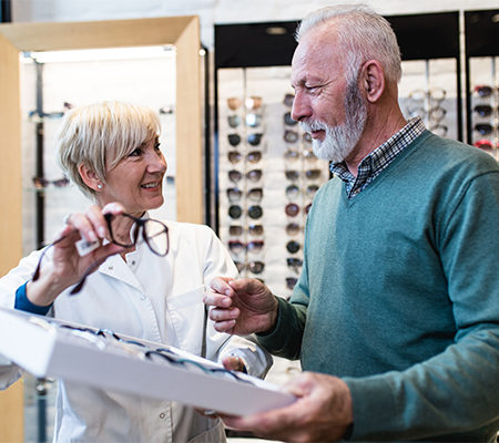 Photo of eye care provider showing glasses to patient