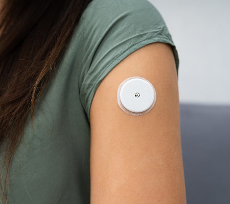 person with diabetes monitoring system or glucose monitor in arm