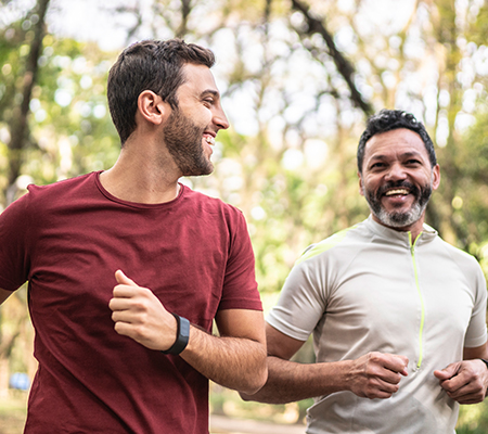 Two men go jogging together.